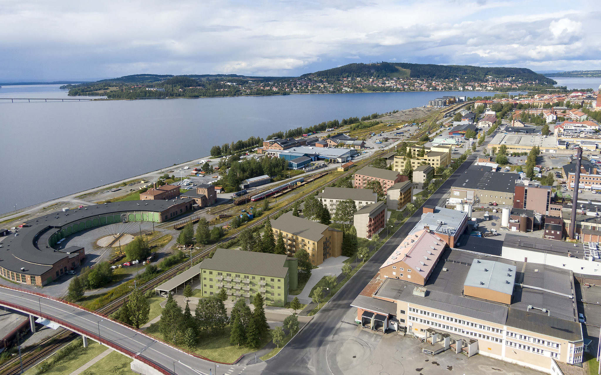 Aerial view of Strandblick in Östersund with residential buildings, forest and water.